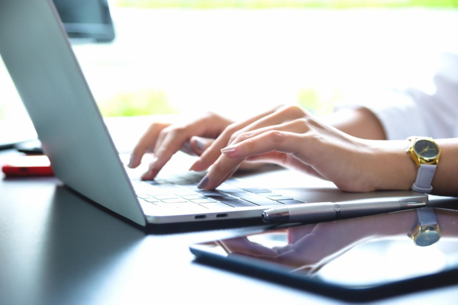 Professional examining financial charts and budget analysis documents with calculator and laptop